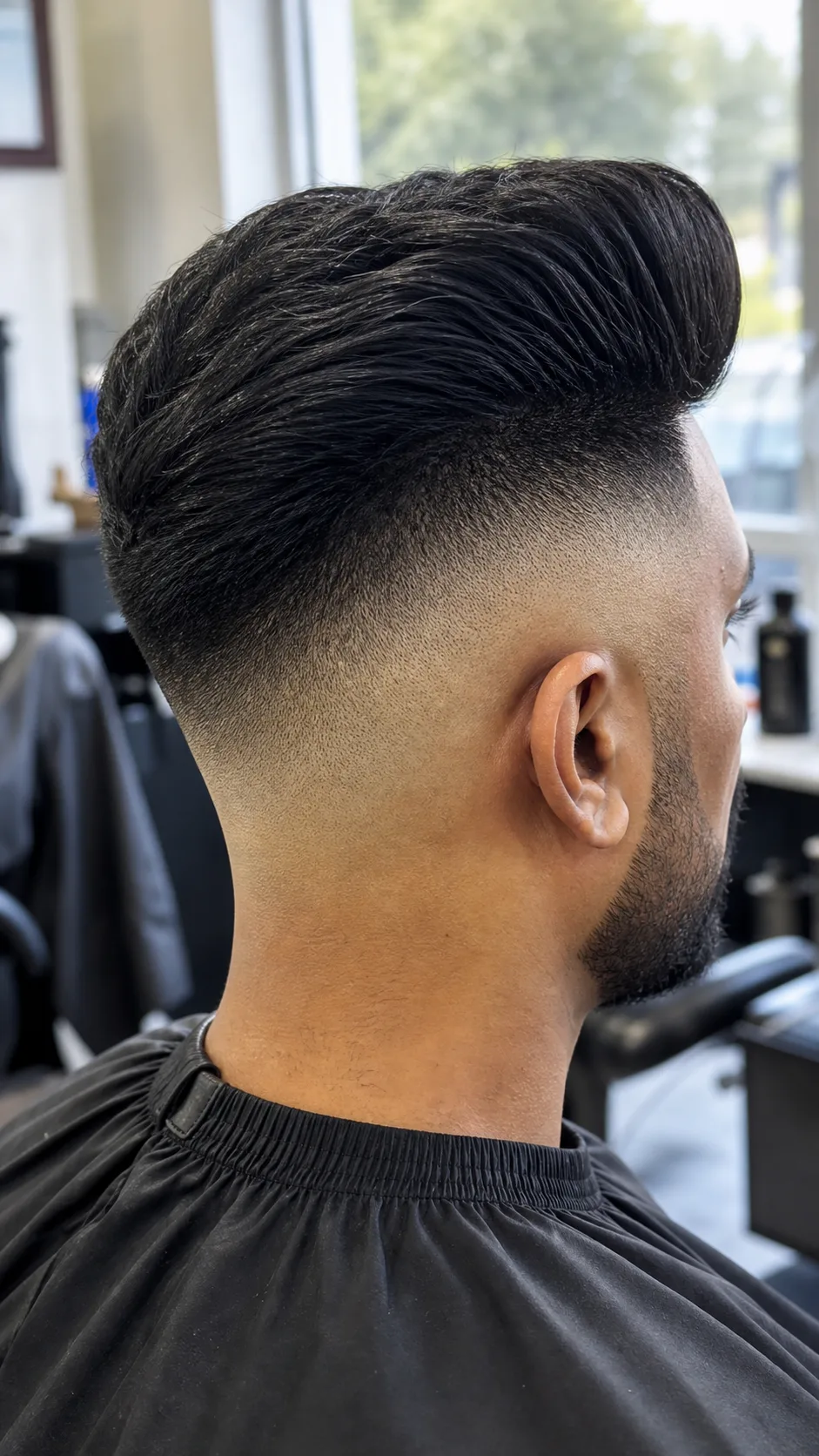 Pompadour high skin fade haircut with side profile focused on fade contrast